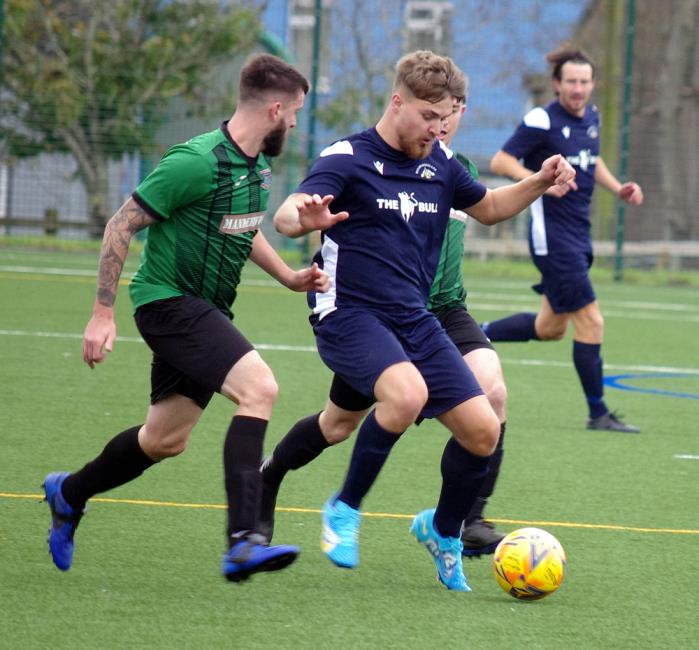 Shane Walsh and Will Evans compete for the ball